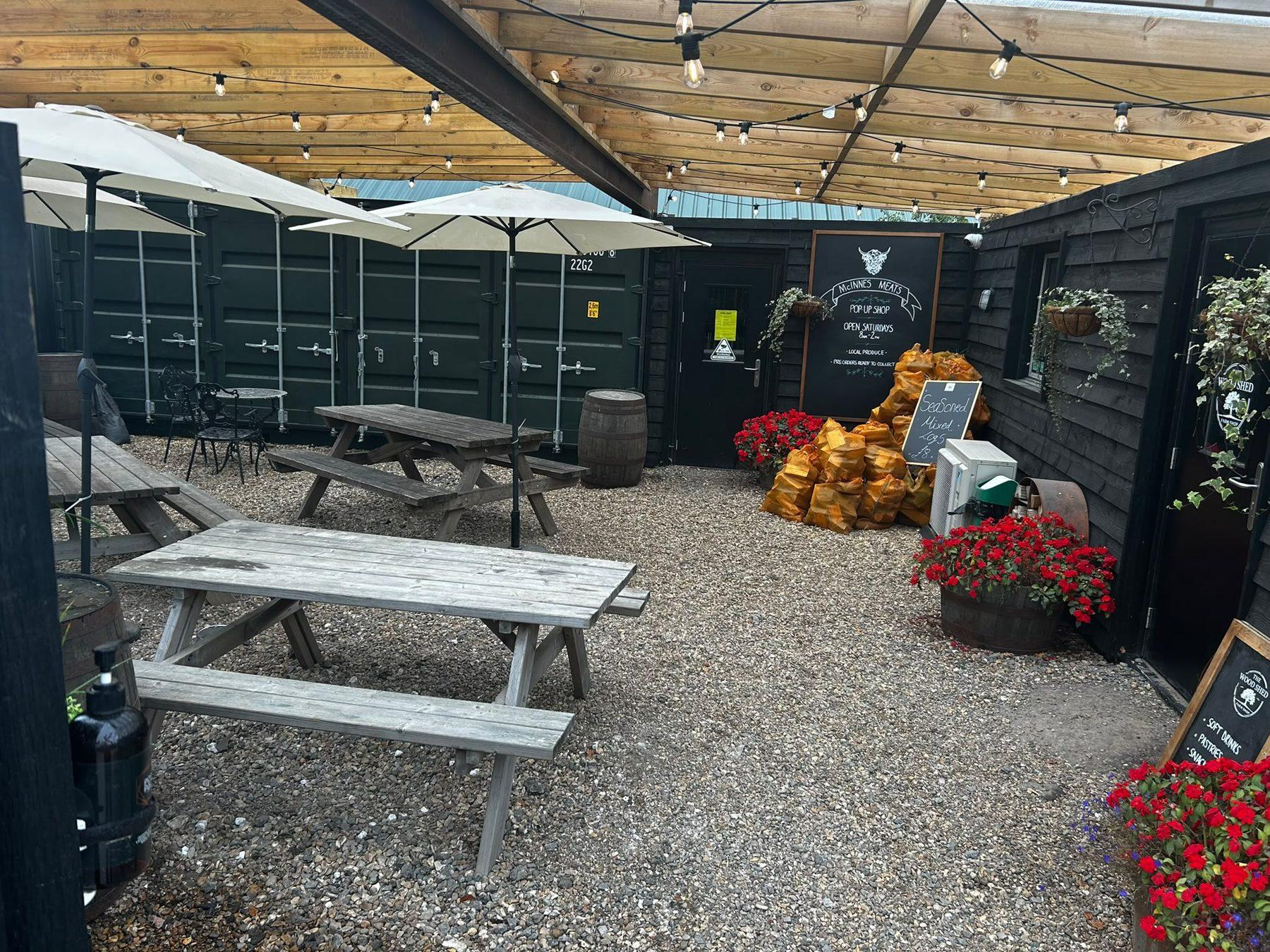 The covered courtyard with picnic tables and festoon lights